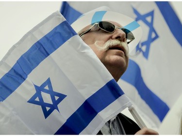 Richard Wyce listens to a speaker at Place du Canada in Montreal Thursday, May 9, 2019 during Yom Ha'atzmaut celebrations marking the 71st Israel Independence Day.