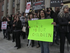 People take part in a rally/protest outside the EMSB school board offices in Montreal Monday, May 13, 2019. The EMSB were then going to have a meeting with parents from the east end of Montreal to discuss the possible of transfer of three schools to a French school board that is suffering from overcrowding.