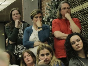 Parents listen during a special EMSB meeting Monday on the possible transfer of three English-language schools to the francophone sector.