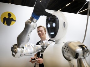 Bernt Bornich of Halodi Robotics controls a robot that is being marketed to help with homeware tasks during the IEEE Robotics & Automation Society convention in Montreal, on Monday, May 20, 2019.