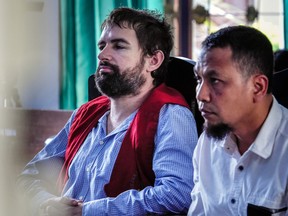 Frenchman Felix Dorfin, left, sits beside his translator after he was sentenced to death by a court in Mataram on the resort island of Lombok on May 20, 2019.