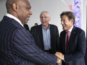 Stephen Bronfman, right, shares a laugh with former Expos players Andre Dawson, left, and Steve Rogers before a news conference marking the Expos' 50th birthday on Tuesday.
