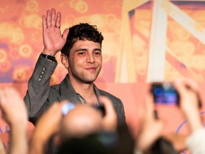 Canadian film director Xavier Dolan waves as he attends a press conference for the film Matthias and Maxime at the 72nd edition of the Cannes Film Festival.