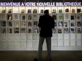 A visitor checks out a selection of books at the newly opened civic library in Pierrefonds-Roxboro.