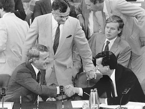 Premier Robert Bourassa (bottom right) shakes hands with Prime Minister Brian Mulroney at the signing of the Meech Lake Accord in Ottawa on June 3, 1987. In the centre of the photo is Ray Hnatyshyn, then justice minister but later governor general. Former and future Gazette columnist L. Ian MacDonald, then an advisor to Mulroney, is just above Bourassa.