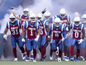 Montreal Alouettes players run onto the field prior to their game against the Ottawa Redblacks in Montreal on July 6, 2018.