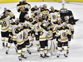 The Boston Bruins celebrate after defeating the Carolina Hurricanes in Game 4 to win the Eastern Conference Final at PNC Arena on May 16, 2019, in Raleigh, N.C.