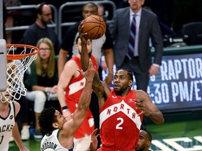 MILWAUKEE, WISCONSIN - MAY 23:  Kawhi Leonard #2 of the Toronto Raptors attempts a shot while being guarded by Malcolm Brogdon #13 of the Milwaukee Bucks in the fourth quarter during Game Five of the Eastern Conference Finals of the 2019 NBA Playoffs at the Fiserv Forum on May 23, 2019 in Milwaukee, Wisconsin. NOTE TO USER: User expressly acknowledges and agrees that, by downloading and or using this photograph, User is consenting to the terms and conditions of the Getty Images License Agreement.