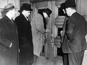 Police, acting on orders from Premier Maurice Duplessis, padlock a building housing the United Jewish People's Order on Esplanade Ave. in Montreal in January 1950.