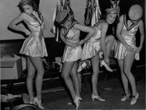 This photograph is date stamped Sept. 14, 1940. The original cutline: "This backstage peek shows three members of the MRT Tin Hats' comely voluntary troupe who will give a War Time Revue in the Blue Room of the Domaine d'Esterel at St. Margaret's next Saturday in aid of their military entertainment programme. For information phone PL1. 9427 -- a taxi arrangement places the return fare at $2.00." The revue was actually the Tin Hat (not Hats) revue; the photo was published with the woman at the left cropped out.