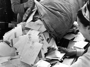 In this photo from our archives dated May 8, 1968, one of many mailbags of entries in Montreal's "voluntary tax" lottery are emptied.