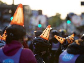 Construction cones, a recurring theme as cyclist wait in queue during the Tour la Nuit in Montreal in 2019.