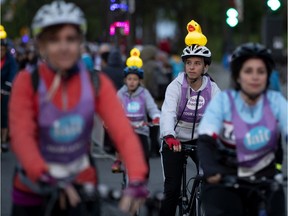 A family sports lit-up rubber ducks as their theme while taking part in the Tour la Nuit in Montreal, on Friday.