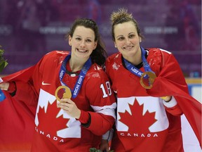 Gold medalists Catherine Ward, left, with Marie-Philip Poulin celebrate at the Sochi Winter Olympics on Feb. 20, 2014, in Russia. Ward was  selected Thursday for enshrinement in the McGill University Sports Hall of Fame.