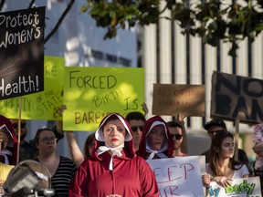 Margeaux Hartline, dressed as a handmaid, during a rally against HB314, the near-total ban on abortion bill, outside of the Alabama State House in Montgomery, Ala., on Tuesday May 14, 2019.  (Mickey Welsh/The Montgomery Advertiser via AP) ORG XMIT: ALMON107