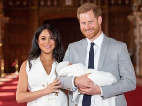 Britain's Prince Harry, Duke of Sussex (R), and his wife Meghan, Duchess of Sussex, pose for a photo with their newborn baby son in St George's Hall at Windsor Castle in Windsor, west of London on May 8, 2019.