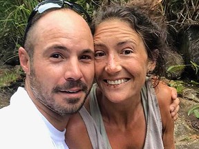 Amanda Eller, sunburned, blistered and smiling, with one of her rescuers, Javier Cantellops.