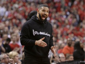 Drake reacts courtside in Toronto Saturday during the Raptors' game against the Milwaukee Bucks. If you're inclined to defend the rapper, Jack Todd writes, ask yourself how he would react if a deluded super-fan were to climb on the stage and start massaging his neck during a concert.