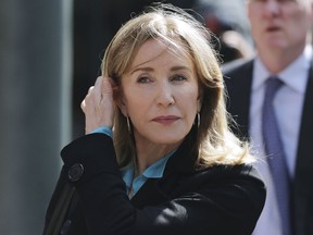 FILE - In this April 3, 2019 file photo, actress Felicity Huffman arrives at federal court in Boston to face charges in a nationwide college admissions bribery scandal. Huffman will plead guilty on May 13 to charges that she took part in the cheating scam. She had been scheduled to enter her plea on May 21, but a judge agreed to move up the hearing because the lead prosecutor will be out of town.