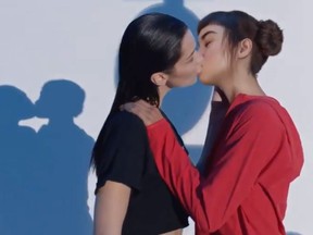 Bella Hadid, left, and Lil Miquela kiss in an ad for Calvin Klein. (Twitter screengrab)