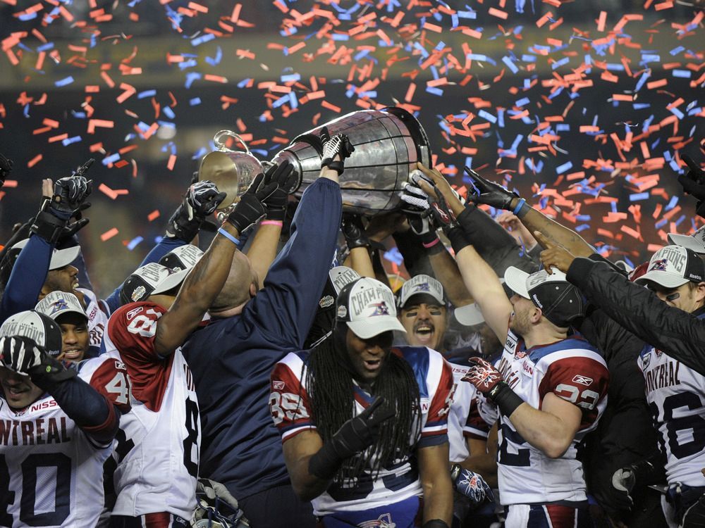 Toronto Argonauts players look at the CFL East division trophy after  defeating the Montreal Alouettes in