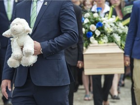 The casket of a seven-year-old girl who was found in critical condition inside of a home and later died is carried from the church after funeral services, Thursday, May 9, 2019 in Granby.