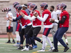 Montreal Alouettes quarterbacks Jeff Mathews, Matthew Shiltz, Vernon Adams Jr. and Antonio Pipkin, left to right, go through a drill during a practice in Montreal on Monday, May 27, 2019.