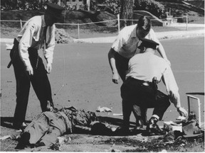Sgt.- Maj. Walter Leja, an army demolition expert, lost his left hand and suffered severe face and chest injuries when a bomb planted by FLQ terrorists in a Westmount mailbox exploded as he was dismantling it on May 17, 1963. This photo, taken seconds after the explosion by Garth Pritchard of the Montreal Gazette, won The Canadian Press picture-of-the-month award for May.