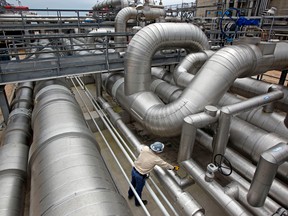 A supervisor checks valves among transfer pipes at the Freeport LNG facility in Quintana, Texas.