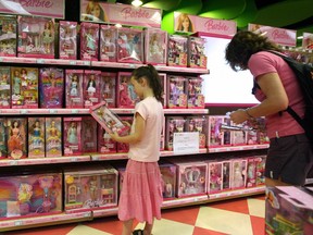 A young girl holds a Barbie doll next to a notice saying that the toy "Barbie and Tanner" made by U.S. toy giant Mattel, which has just been recalled in the US, is out of stock at a Toys "R" Us store in Shanghai, 15 August 2007. Thousands of North Korean women and girls are being forced into marriage and prostitution and subjected to sadistic abuse by trafficking gangs running a multimillion-dollar illicit sex industry in China.