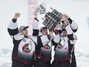 Rouyn-Noranda Huskies' Samuel Harvey and teammates Rafael Harvey-Pinard, Peter Abbandonato and Jacob Neveu, left to right, hoist the Memorial Cup after defeating the Halifax Mooseheads 4-2, in Halifax on Sunday, May 26, 2019.
