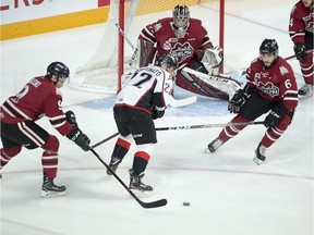 Guelph Storm's Nick Suzuki, left, and Sean Durzi, right, defend against Rouyn-Noranda's Peter Abbandonato in 2019 Memorial Cup action in Halifax on Saturday, May 18, 2019.