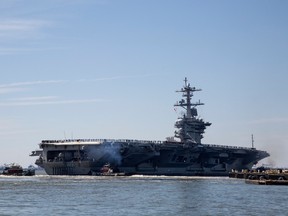 In this April 1, 2019, file photo, the USS Abraham Lincoln deploys from Naval Station Norfolk, in the vicinity of Norfolk, Va. The White House said Sunday, May 5, that the U.S. is deploying military resources to send a message to Iran. White House national security adviser John Bolton said in a statement that the U.S. is deploying the USS Abraham Lincoln Carrier Strike Group and a bomber task force to the U.S. Central Command region, an area that includes the Middle East.