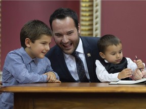 “We will continue to invest in daycare services,” says Quebec Family Minister Mathieu Lacombe, pictured with sons Justin, left, and Thomas at his swearing-in ceremony in October.