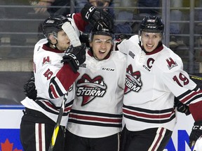 Nick Suzuki celebrates his goal with Guelph Storm teammates Dimitri Samorukov (left) and Isaac Ratcliffe during the second period of their game in London, Ont. on Tuesday, April 16, 2019.