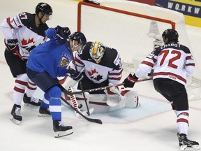 Canada's goaltender Matt Murray and\ teammates Thomas Chabot, right, and Shea Theodore, left, make a save against Finland's Jere Sallinen, second left, during the Ice Hockey World Championships at the Steel Arena in Kosice, Slovakia, on Friday, May 10, 2019.