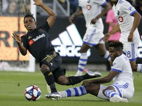 Los Angeles FC forward Latif Blessing (7), of Ghana, is tackled by Montreal Impact midfielder Orji Okwonkwo, of Nigeria, during the first half of an MLS soccer match in Los Angeles, Friday, May 24, 2019.