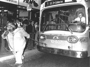 The Great Antonio Barichievich pulls a Montreal Transit Commission bus down Ste-Catherine St. This photo was published in the Montreal Gazette on May 25, 1979.