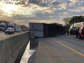 This photo released by the Indiana State Police shows a semi-trailer hauling honey overturned on a northwestern Indiana highway, spilling some of the sticky substance and restricting travel for hours in Hammond, Ind.