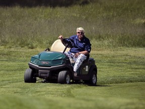 John Daly drives a golf cart along the 16th fairway during the first round of the PGA Championship golf tournament in May 2019. The amount of energy expended during a round of golf varies.