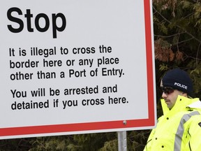 An RCMP officer stands guard at the border leading into Canada from the United States on Wednesday, April 18, 2018 near Champlain, NY.