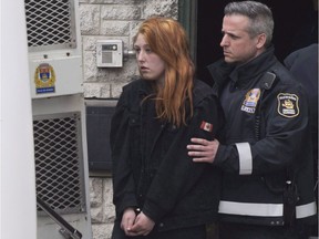 Audrey Gagnon is escorted by police on her way to the courthouse in Quebec City, Thursday, April 19, 2018. A Quebec woman whose two-year-old daughter was found dead last week has been charged with second-degree murder in her slaying. The charge was laid against Audrey Gagnon today as she appeared before a judge at the Quebec City courthouse.