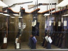 Hunting rifles are seen on display in a glass case at a gun and rifle store in downtown Vancouver in 2010. The Quebec government is crediting its new gun registry law for a major spike in the number of long guns voluntarily handed over to police for destruction. Between April 1, 2018, and March 31, 2019, 5,250 long-guns were voluntarily given to authorities to be destroyed, according to provincial police spokesperson Joyce Kemp.