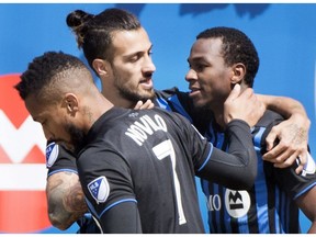 Montreal Impact's Omar Browne, right, celebrates with teammates Maximiliano Urruti, centre, and Harry Novillo after scoring against the Chicago Fire during second half MLS soccer action in Montreal, Sunday, April 28, 2019.