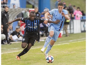 Montreal Impact's Zachary Brault-Guillard, left, challenges New York FC's Ben Sweat during second half MLS soccer action in Montreal on Saturday, May 4, 2019.