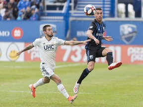 Montreal Impact's Daniel Lovitz, right, is challenged by New England Revolution's Diego Fagundez during first half MLS soccer action in Montreal on Saturday, May 18, 2019.