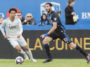 Impact's Ignacio Piatti is challenged by New England Revolution's Tajon Buchanan during second half in Montreal on May 18, 2019.