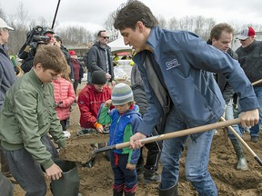 Prime Minister Justin Trudeau helps fill sandbags in Constance Bay, Ont., on April 27. Nine Montreal-area mayors have issued an open letter titled: "Flooding 2019 — Once the cameras leave, so do the politicians."