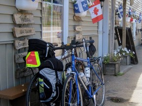 Quebec and Canadian flags greet visitors in 2015 at a shop on Isle-aux-Coudres, where a road circling the island shore provides a perfect loop for lovers of quiet roads, gentle hills, flats along the water and eye-candy vistas of mountains you don't have to climb. A free 15-minute car ferry gets you to the island from the Charlevoix mainland.