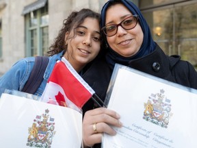 "So you want me to take off my scarf. If I take off my scarf, what does that mean? Will I no longer be different? Will I be like everyone else? No I'll always be different," says  new citizen Hayat Sbiti, with daughter Rania Raissali, who say they have been warmly welcomed in Quebec.